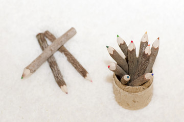 Color wooden pencils is on the light background. Unusual pencils for drawing made how logs. 