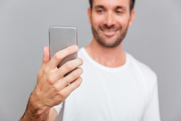 Portrait of a smiling man making selfie photo