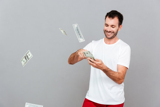 Handsome young casual man counting money