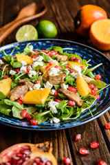 Arugula salad with pomegranate, chicken meat, persimmons and Feta cheese