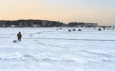 Winter fishing in Siberia - fisher's tents on ice of Ob reservoi