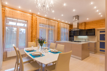 Dining area table and chairs, accent lighting and view windows in contemporary upscale home interior