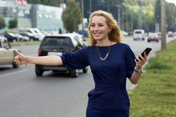 woman with cellphone is catching the taxi