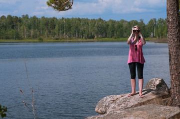 Fototapeta na wymiar Girl with binoculars