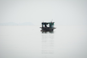 A boat go to fishing at Bangpakong river in Chachengsao Provice east of Thailand.(on white background)