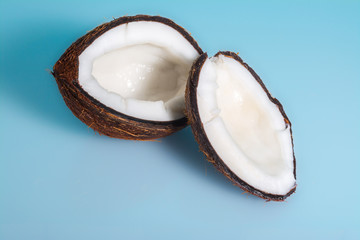 Split coconut on blue background 