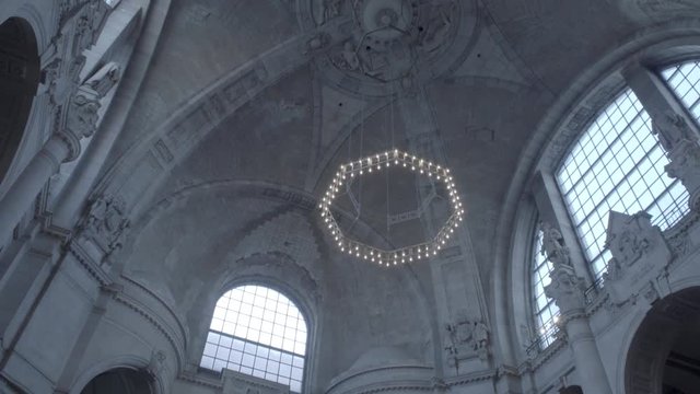New Town Hall in Hanover, Germany. Tilt from the ceiling of the dome with it's dome lamp in 4K and S-Log3. Long shot. Autumn. Neues Rathaus Hannover.