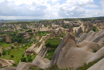 Fototapeta na wymiar Cappadocia, Turkey fairy chimneys tall, cone-shaped rock formations clustered in Monks Valley, Göreme 