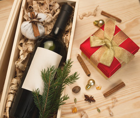 Wine bottle in wooden box and spices for mulled wine