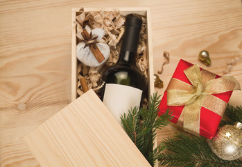 Wine bottle in wooden box and spices for mulled wine