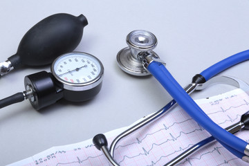 Stethoscope head and silver pen lying on cardiogram  clipboard pad. Cardio therapeutist assistance, physician make cardiac physical, pulse beat measure document, arrhythmia idea, pacemaker concept