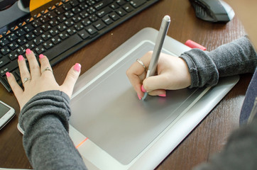 Young woman using graphic tablet