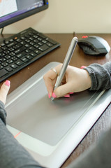 Young woman using graphic tablet