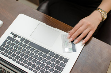 Young woman using credit card