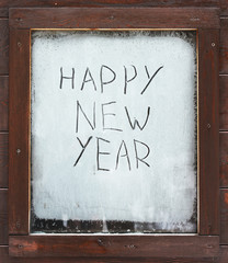The inscription "Happy New Year" on the frosty window