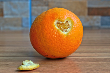 An orange with a heart shape cut out