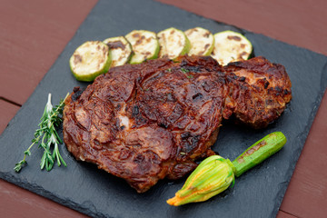 Rib eye steak with vegetables on slate plate