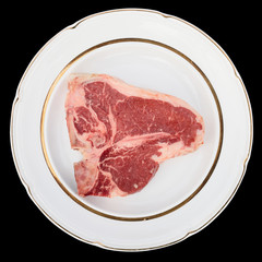 Raw T-bone steak on a rustic plate, isolated