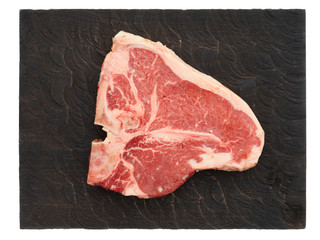 Raw T-bone steak on cutting board, isolated