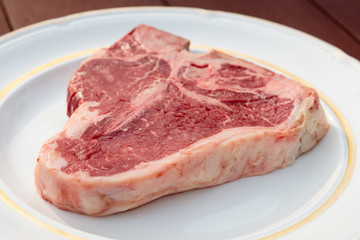 T-bone steak in a white plate