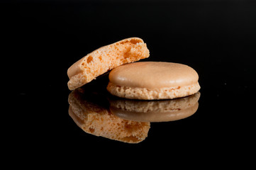 Sweet and colorful french macaroon or macaron on black background
