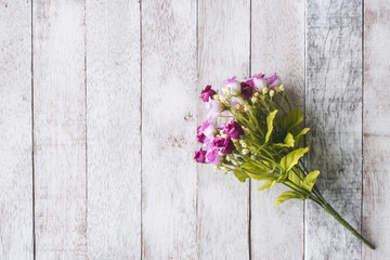 Top view of  Pink flowers on wooden table background.