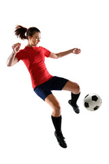 Fototapeta na wymiar Female Soccer Player Kicking Ball