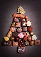 Fototapeta na wymiar Different chocolates in the shape of a Christmas tree