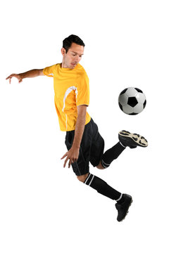 Soccer Player Back Kicking Ball