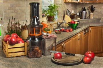 Domestic production of fresh apple juice. Fruit processing. Production of fruit drinks. Healthy lifestyle.
