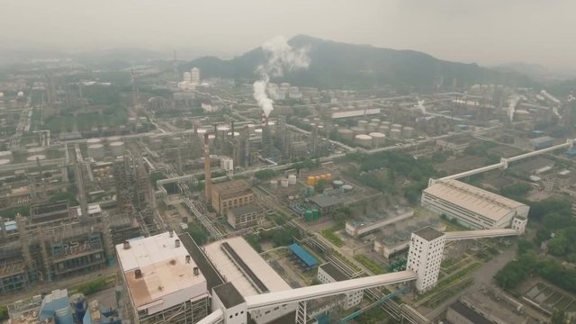 Aerial overview of an oil refinery, heavy industry and polluting smokestacks in Guangzhou, China