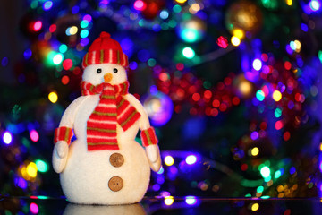 Christmas snowman on the background of Christmas lights bokeh
