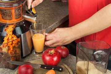 Domestic production of fresh apple juice. Fruit processing. Production of fruit drinks. Healthy lifestyle.
