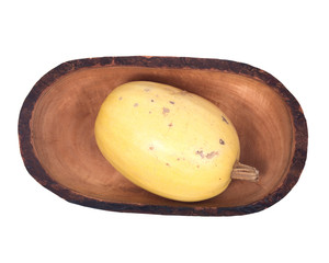 Amish farm spaghetii squash in olive wood bowl isolated on white background