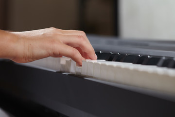 female's  hands playing piano