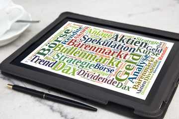 tablet with stock market word cloud