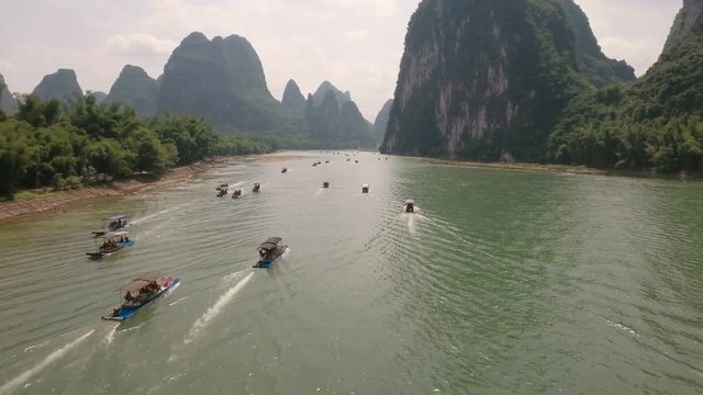 Aerial view of Chinese tourists sailing across the Li river on rafts