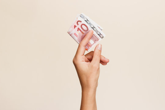 Woman's Hand With Money On A Light Background