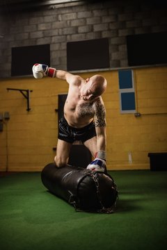 Boxer practicing boxing with punching bag
