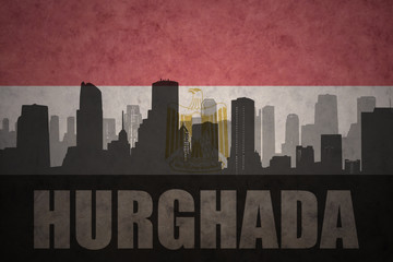 abstract silhouette of the city with text Hurghada at the vintage egyptian flag