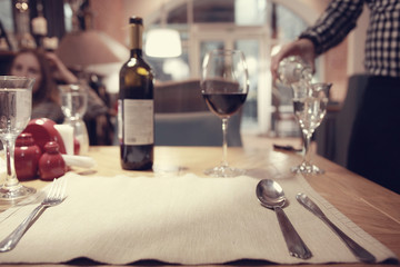 Naklejka na ściany i meble glass of red wine in restaurant interior