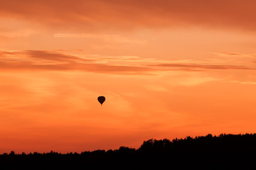 Hot air balloon flying at sunset sky