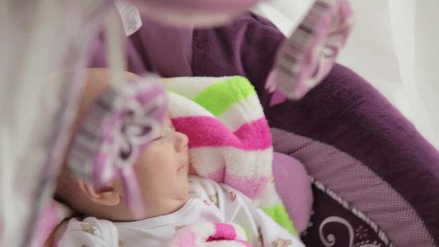 little girl sleeping in the cradle