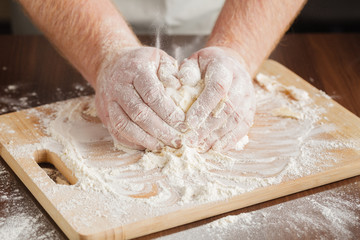 Christmas baking. Man in apron making dough for Christmas cookie