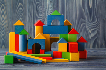 Wooden cubes with space for text and colourful castle on blue ba