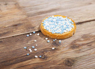 Traditional Dutch birth celebration biscuit with blue muisjes on wooden background