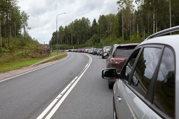 Fototapeta na wymiar Cars waiting in line to enter the checkpoint Brusnichnoe on the Russian-Finnish border