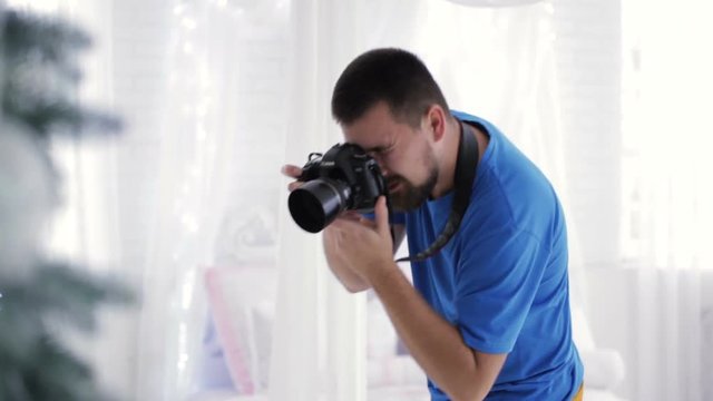 Young photographer with beard making photo
