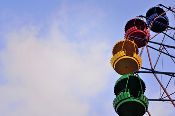 Ferris wheel on the background of blue sky