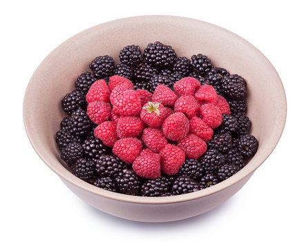 Ceramic plate with heart shaped berries isolated on the white background with clipping path. Top side view.